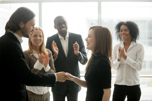 smiling young woman getting hired for a job